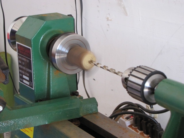 turn the lathe on and start drilling the hole
